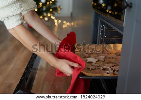 Woman taking out ready Christmas cookies