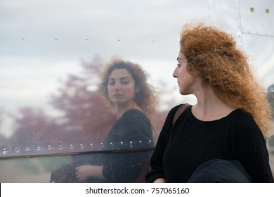 woman taking a passing look at reflection in side of American style diner like a huge mirror
 - Powered by Shutterstock