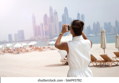 Woman Taking Phone Picture Of Dubai Skylines. Female Tourist Looking At View Taking Snapshots. UAE