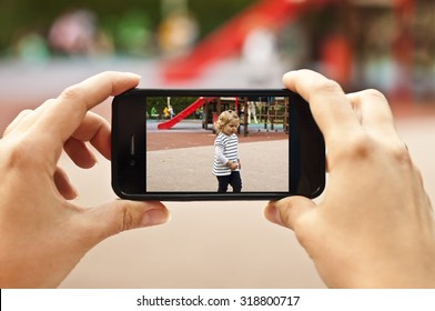 Woman Taking A Photo Of Baby Girl With Smartphone - POV Shot