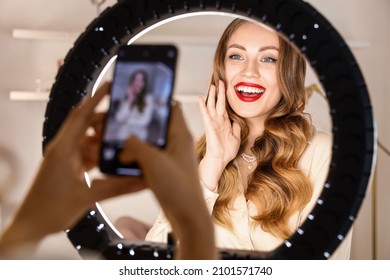 Woman taking photo of beautiful model in makeup room - Shutterstock ID 2101571740