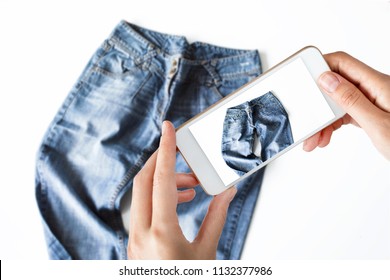 Woman Taking A Photo Of Blue Jeans