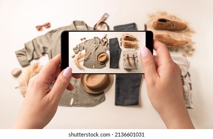 Woman Taking Photo Of Man’s Casual Clothes (jeans, Khaki Shirt) With Smartphone. Blogger, Influencer Or Stylist Capturing Fashion Outfit And Accessories For Social Media. 