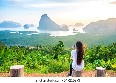 Woman Is Taking Photo With Cell Telephone Camera Of Phang Nga Bay Islands,Thailand.