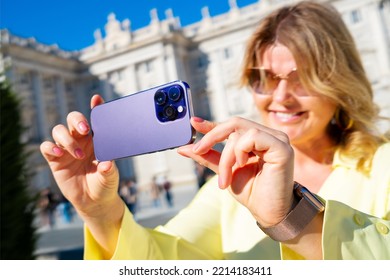 Woman taking photo with mobile phone