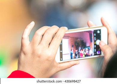 Woman Taking Photo With Mobile Phone