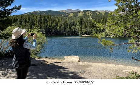 Woman Taking Photo of the Rocky Mountains in Colorado - Powered by Shutterstock