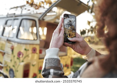  Woman Taking Photo of Vintage Camper Van on Smartphone - Powered by Shutterstock