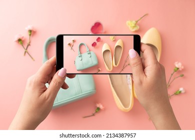 Woman taking photo of yellow ballet flats shoes and mint handbag with smartphone. Blogger, influencer or stylist capturing spring fashion accessories for social media. Pastel pink background.