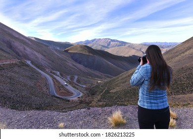 Woman Taking A Picture Of A Montain Road 