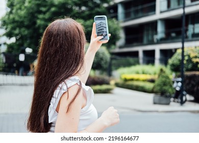 Woman Taking Picture Of The New House With Mobile Phone. Homebuyer Using Smartphone To Photograph The Apartment