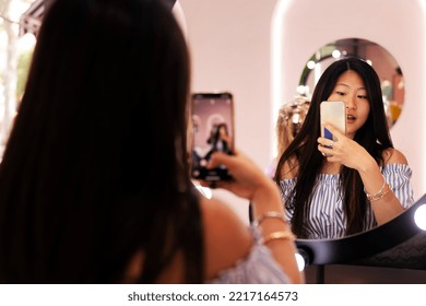 Woman Taking Picture With Phone Of Her New Haircut