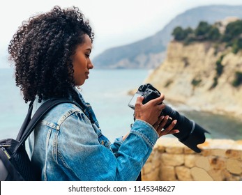 Woman Taking A Picture Of A Sea Landscape With A Professional Camera