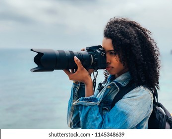 Woman Taking A Picture Of A Sea Landscape With A Professional Camera