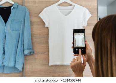 Woman taking picture of used clothes. Selling used clothes concept. 