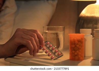 Woman Taking Pills From Nightstand Indoors, Closeup. Insomnia Treatment