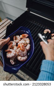 Woman Taking Prawns Off The Bbq With Tongs