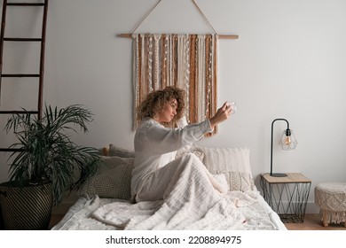 Woman taking self shot at home - Shutterstock ID 2208894975