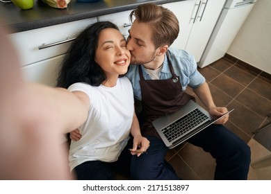 Woman Taking Selfie With Romantic Man On Kitchen Floor