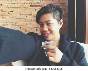 Woman taking a selfie with water drink - Shutterstock ID 581053195