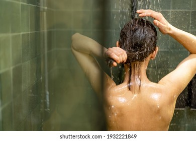 Woman taking shower and relaxing under warm running water. Rinse shampoo and enjoying during hot water bath.  - Powered by Shutterstock