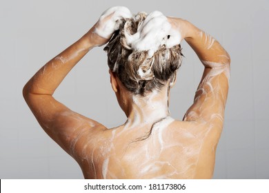 Woman Taking A Shower And Shampooing Her Hair