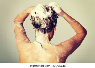 Woman Taking A Shower And Shampooing Her Hair