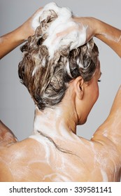 Woman Taking A Shower And Shampooing Her Hair