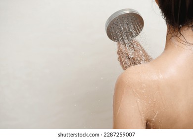 woman taking shower and washing hair with shampoo - Shutterstock ID 2287259007