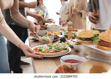 Woman Taking Slice Of Pizza From Buffet Indoors, Closeup. Brunch Table Setting