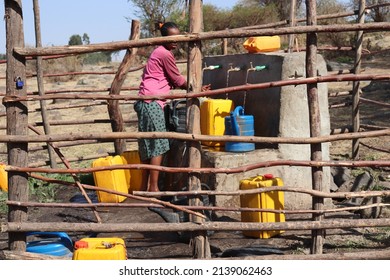 A Woman Taking Some Potable Water In Africa