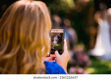 Woman taking wedding selfie outdoors - Powered by Shutterstock