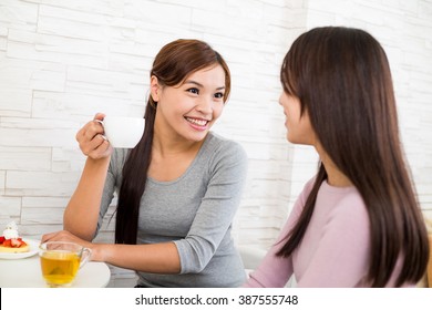 Woman Talk To Each Other At Coffee Shop