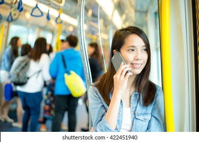 Woman talk to mobile phone in train compartment at hong Kong - Powered by Shutterstock