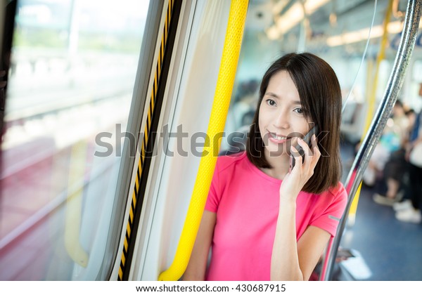 Woman talk to mobile phone\
in train