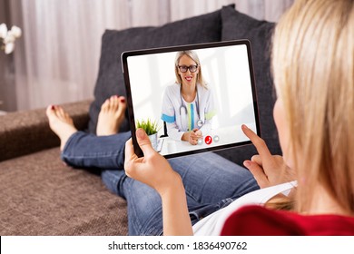 Woman Talking With Doctor On Video Call On Tablet