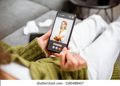 Woman talking with a doctor online using smartphone, feeling bad at home, close-up on phone screen. Concept of telemedicine and patient counseling online - Shutterstock ID 1585488457
