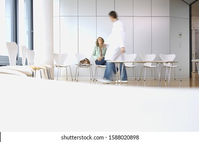 Woman Talking To Doctor In Waiting Room