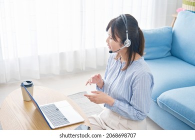 Woman Talking With The Head Set At Home