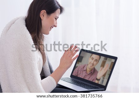 Woman talking with man via skype