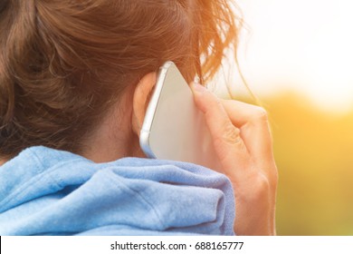 Woman Talking On Cell Phone, Back View