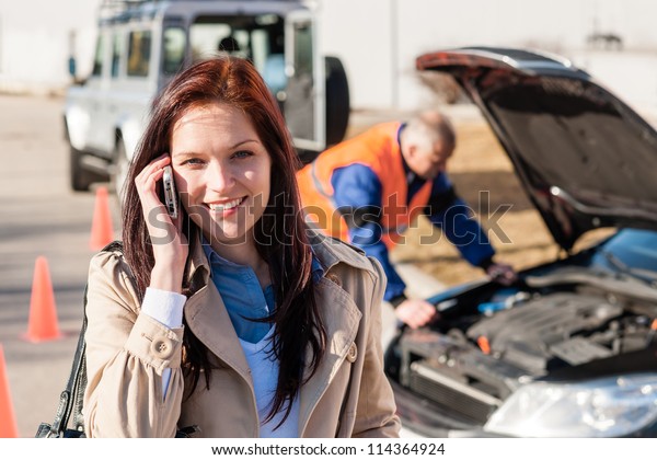 Woman talking on cellphone after car breakdown\
trouble problem mechanic