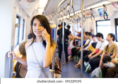 Woman Talking On Cellphone Inside Train Compartment