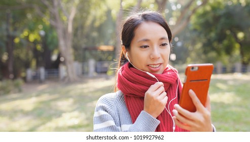 Woman talking on cellphone in the park  - Powered by Shutterstock