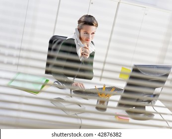 woman talking on mobile phone in office - Powered by Shutterstock