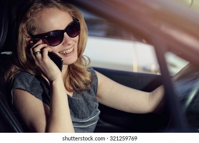 Woman Talking On The Phone In The Car