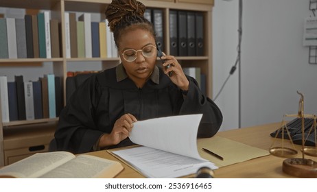 Woman talking on phone reviewing documents in office with scale, paperwork, and shelving in background - Powered by Shutterstock