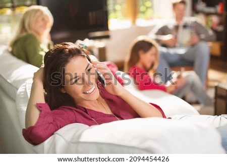Woman talking on phone on sofa