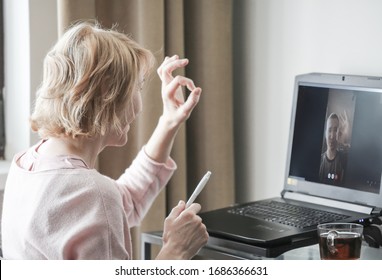 A Woman Talking On Skype At Home Office