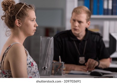 Woman Talking With Policeman At Police Station